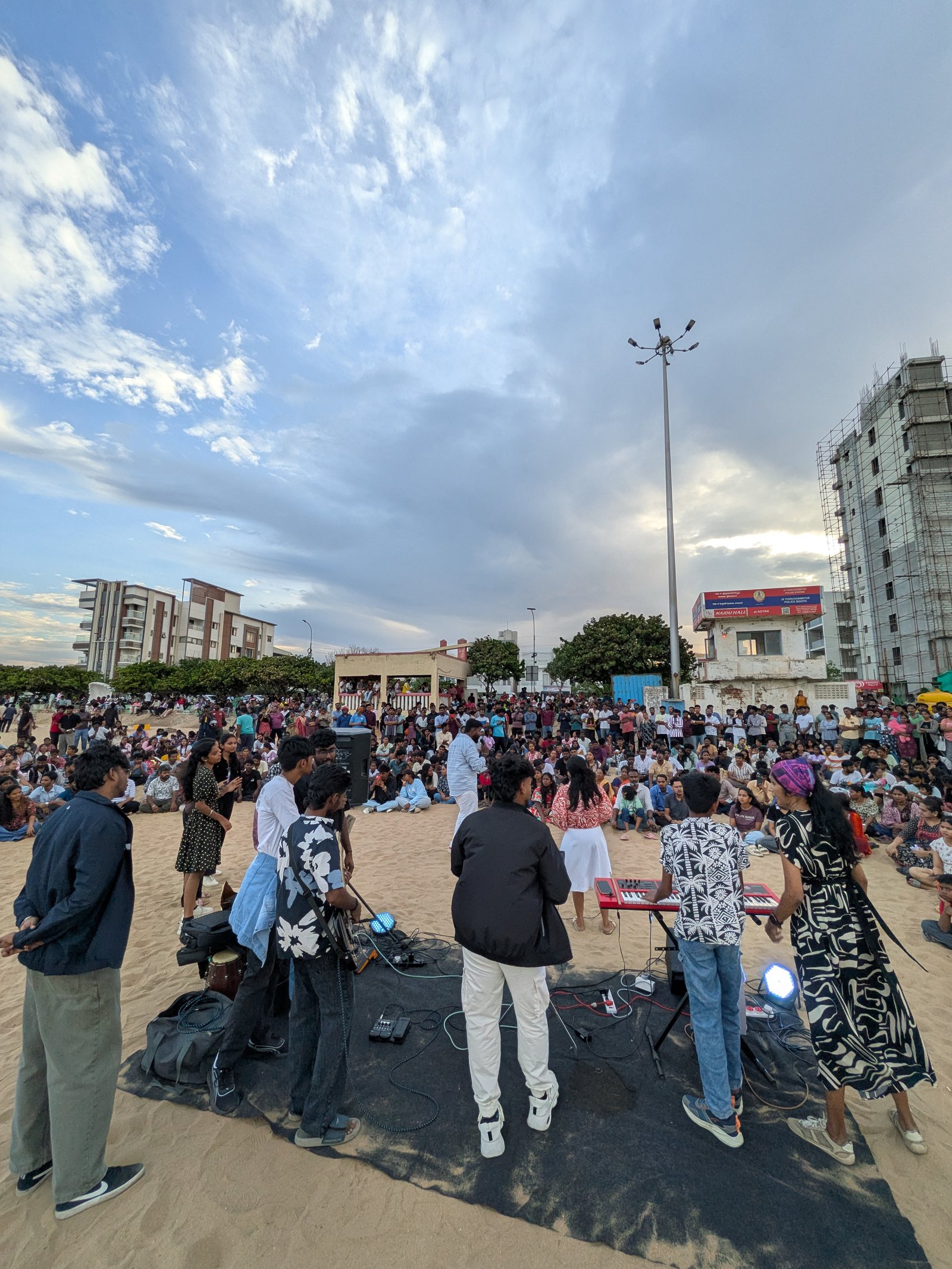 Concert crowd facing a lit stage